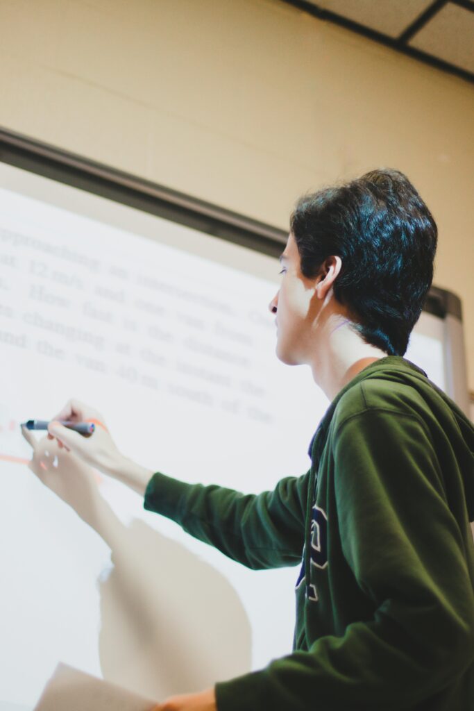 A Man Writing on White Board