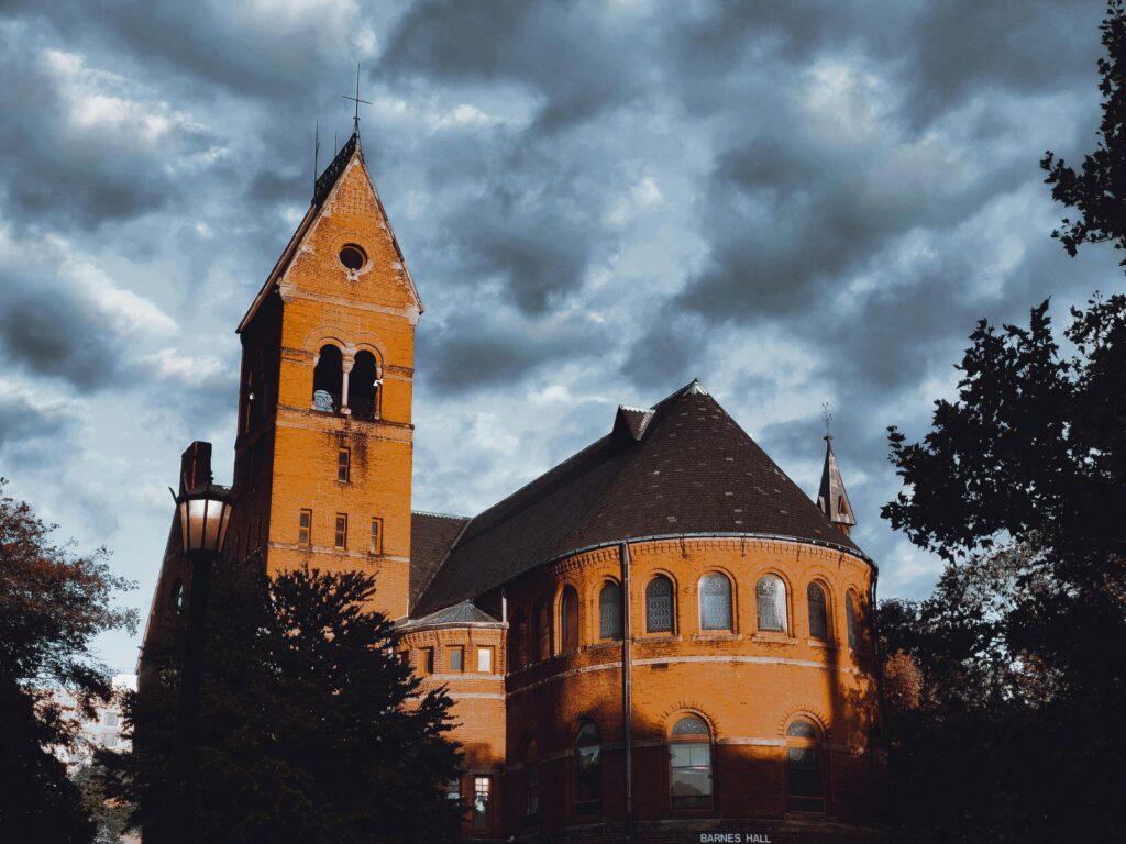 Brown Concrete Building Under Cloudy Sky